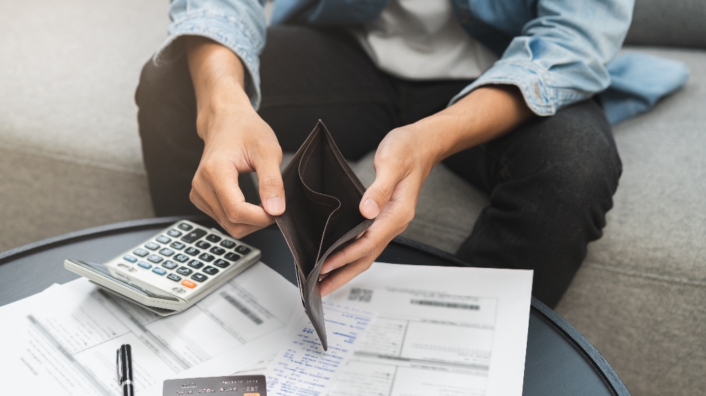 man opens empty wallet